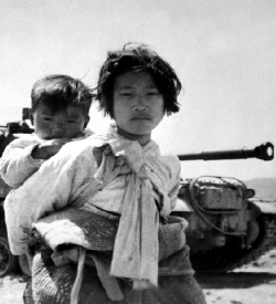 Korean children in front of a tank